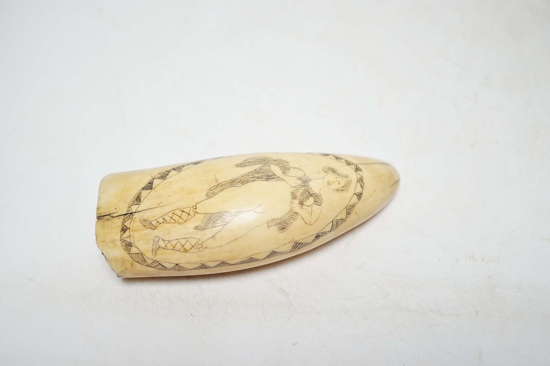A 19th century scrimshaw erotic carved whale tooth, 13cm in length